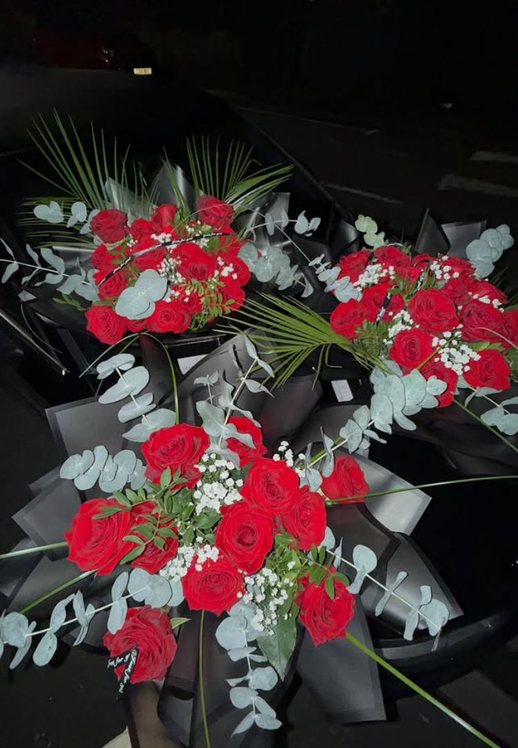 Red rose bouquets with eucalyptus in black wrap