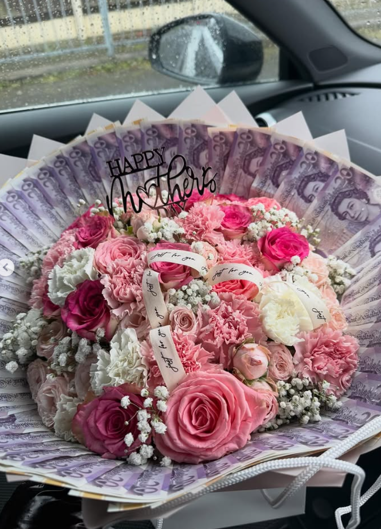 Pink Mother's Day bouquet with a money fan surround